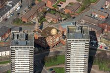 Golden Mosque overshadowed by two of the Seven Sisters towers, Rochdale, 2019. Creator: Historic England