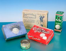 Golf ball boxes and tin of golf ball paint, 1920-1930. Creator: Unknown