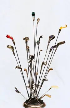 Golfing hatpins and pin holder. Creator: Unknown