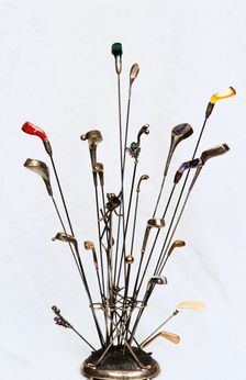 Golfing hatpins and pin holder. Creator: Unknown