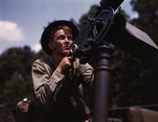 Good man, good gun: a private of the armored forces does some practice..., Fort Knox, Ky., 1942. Creator: Alfred T Palmer