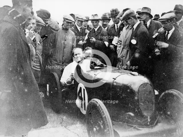 Gordon Taylor in a racing car surrounded by a crowd of men. Artist: Unknown