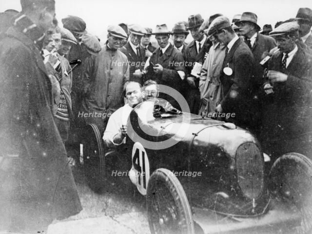 Gordon Taylor in a racing car surrounded by a crowd of men. Artist: Unknown