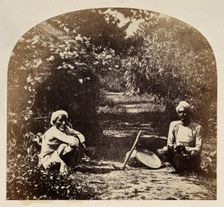 Goruckpoor, India: two men sqatting on a tree-lined path, c1860s. Creator: Unknown