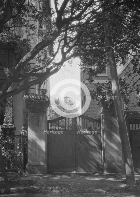 Gate between two buildings, New Orleans, or Charleston, South Carolina, between 1920 and 1926. Creator: Arnold Genthe.