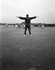 Games master taking a gym class, Airedale school, Castleford, West Yorkshire, 1962. Creator: Michael Walters