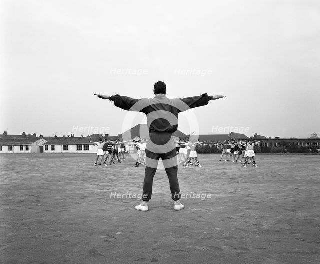 Games master taking a gym class, Airedale school, Castleford, West Yorkshire, 1962. Creator: Michael Walters.