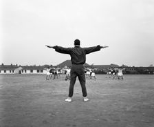 Games master taking a gym class, Airedale school, Castleford, West Yorkshire, 1962. Creator: Michael Walters