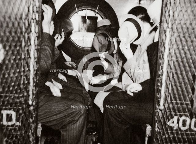 Gangsters in a patrol wagon, New York, USA, mid 1930s. Creator: Unknown.