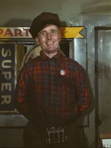 Garage mechanic near Newark, N.J. Badge denotes member of Office of Defense Transportation, 1943. Creator: Marjory Collins