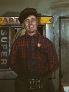 Garage mechanic near Newark, N.J. Badge denotes member of Office of Defense Transportation, 1943. Creator: Marjory Collins