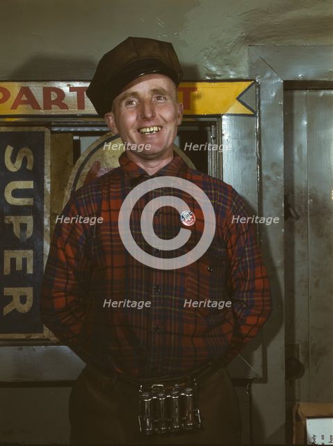 Garage mechanic near Newark, N.J. Badge denotes member of Office of Defense Transportation, 1943. Creator: Marjory Collins.