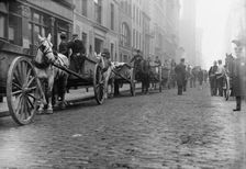 Garbage carts protected by police, 1911. Creator: Bain News Service