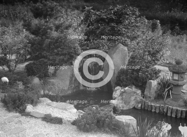 Garden with a Japanese waterfall and a stone lantern, possibly belonging to A.W. Bahr, c1917-1934. Creator: Arnold Genthe.