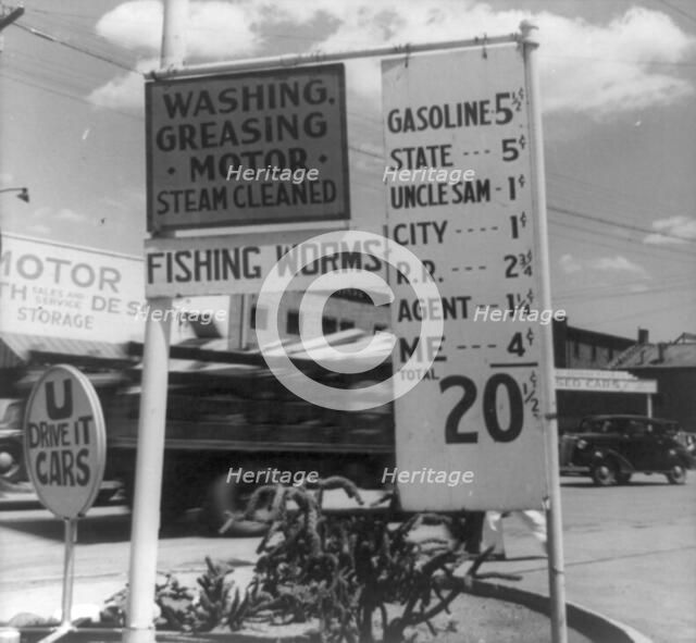 Gas station price analysis, Santa Fe, New Mexico, 1938. Creator: Dorothea Lange.