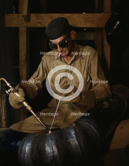 Gas welding a joint in a line...at the TVA's new Douglas Dam on the French Broad River, Tenn., 1942. Creator: Alfred T Palmer.