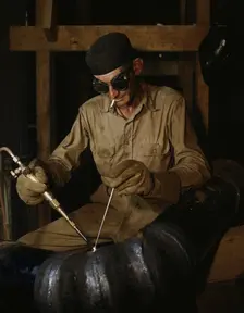 Gas welding a joint in a line...at the TVA's new Douglas Dam on the French Broad River, Tenn., 1942. Creator: Alfred T Palmer