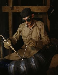 Gas welding a joint in a line...at the TVA's new Douglas Dam on the French Broad River, Tenn., 1942. Creator: Alfred T Palmer