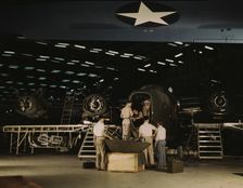 Getting a nose door ready to put on a C-87...Consolidated Aircraft Corp..., Fort Worth, Texas, 1942. Creator: Howard Hollem