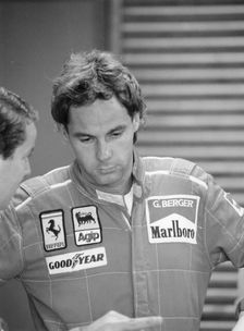 Gehard Berger listening to a member of the Ferrari team, 1988