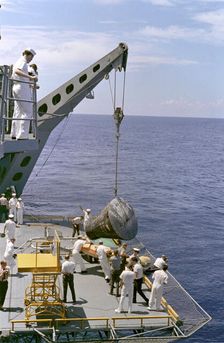 Gemini 5 capsule hoisted onboard recovery ship, 1965. Creator: NASA