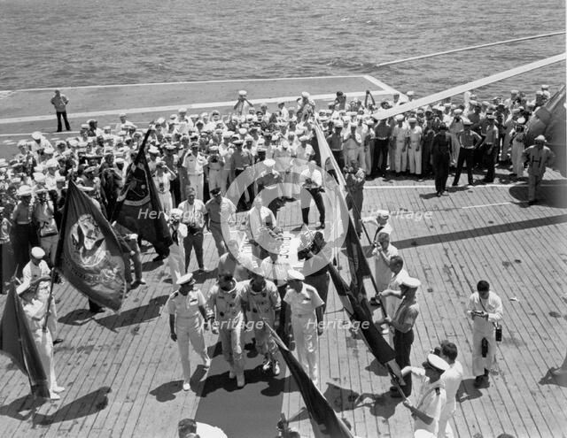 Gemini IV crew arrives on the USS Wasp, June 7, 1965.  Creator: NASA.