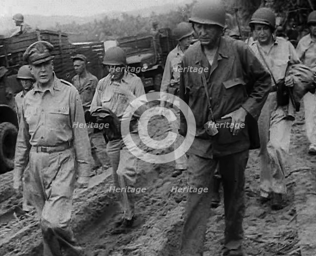 General Douglas MacArthur Walking With American Troops in the Pacific Campaign, 1943. Creator: British Pathe Ltd.