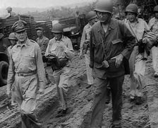 General Douglas MacArthur Walking With American Troops in the Pacific Campaign, 1943. Creator: British Pathe Ltd