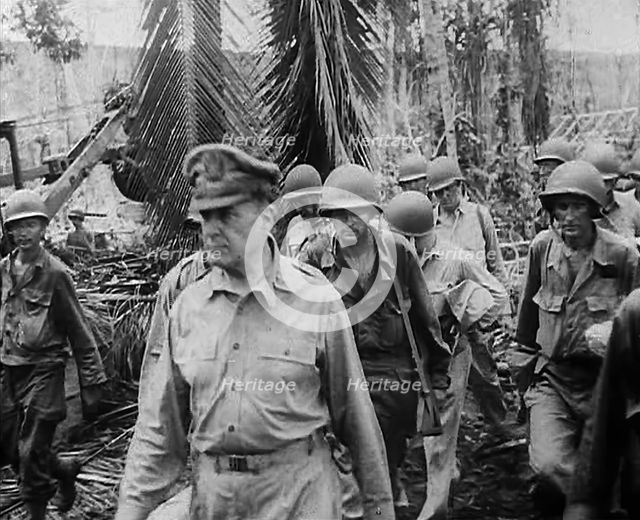 General Douglas MacArthur Walking With American Troops Through Jungle in the Pacific Campaign, 1943. Creator: British Pathe Ltd.