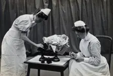 General Lying In Hospital, York Road, Lambeth: nurses weighing a baby, 1906 Creator: Unknown