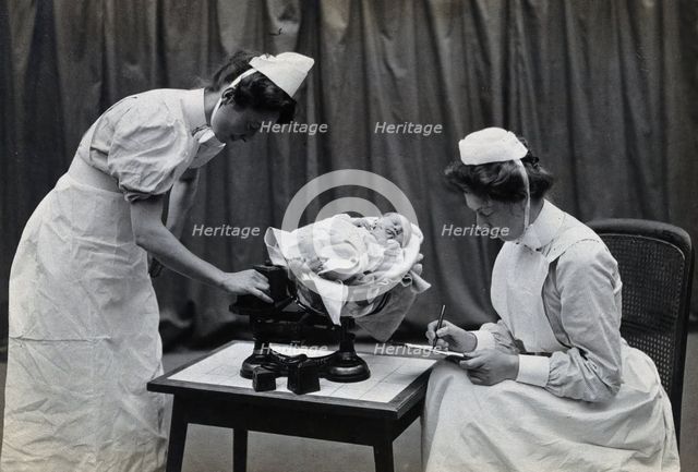 General Lying In Hospital, York Road, Lambeth: nurses weighing a baby, 1906 Creator: Unknown.