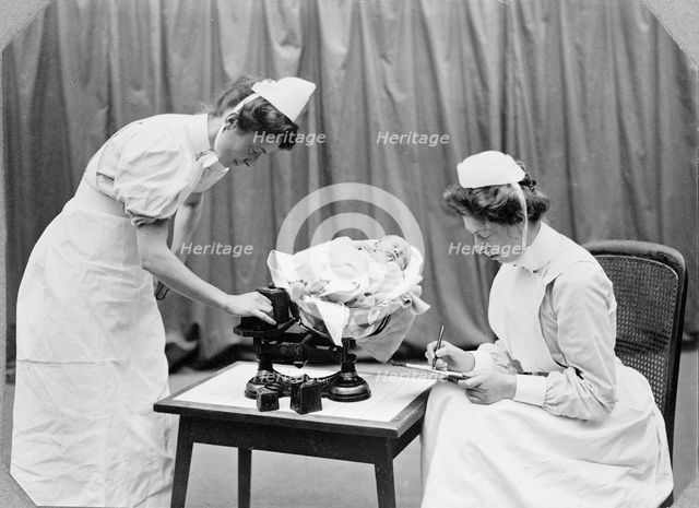 General Lying In Hospital, York Road, Lambeth: nurses weighing a baby, 1908. Creator: Unknown.