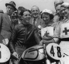 Geoff Duke on Norton, with nurses after race in 1951. Creator: Unknown