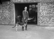 Geoffrey Baker and his alsatian. Artist: Bill Brunell