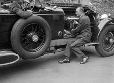 Geoffrey Baker inspecting the engine of a Minerva car. Artist: Bill Brunell