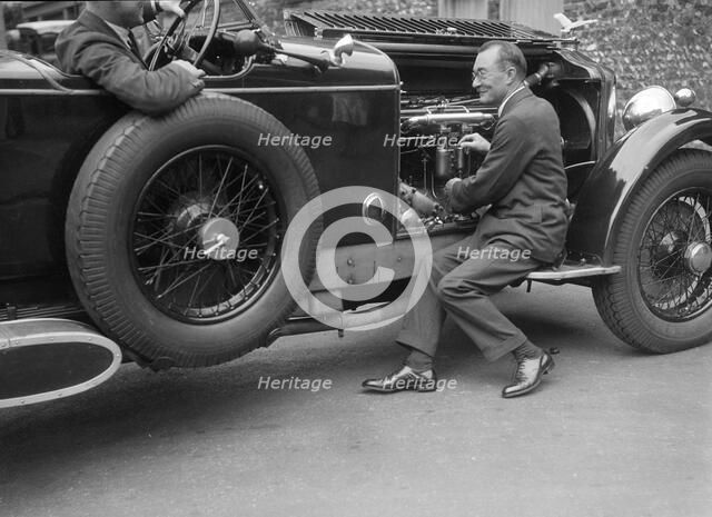 Geoffrey Baker inspecting the engine of a Minerva car. Artist: Bill Brunell.