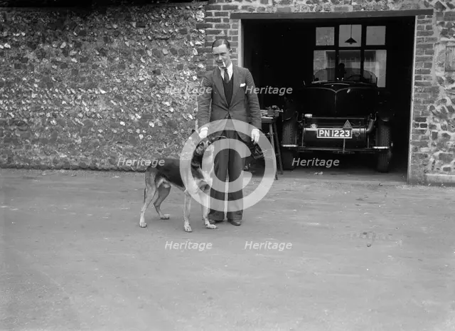 Geoffrey Baker standing in front of a Minerva 5954 cc car. Artist: Bill Brunell.