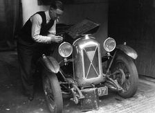 Geoffrey Baker working on a Salmson 1090cc car. Artist: Bill Brunell