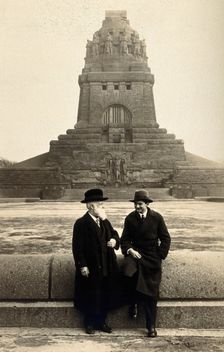 Georg Sticker and an unknown companion, in front of a war memorial (?). Creator: Unknown