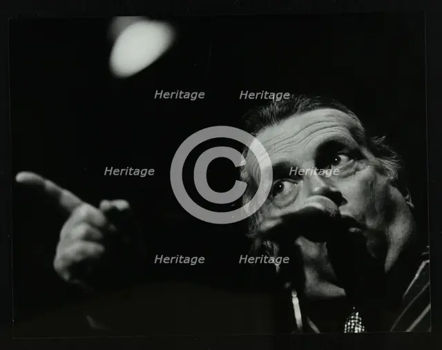George Melly on stage at the Forum Theatre, Hatfield, Hertfordshire, 8 April 1983. Creator: Denis Williams.