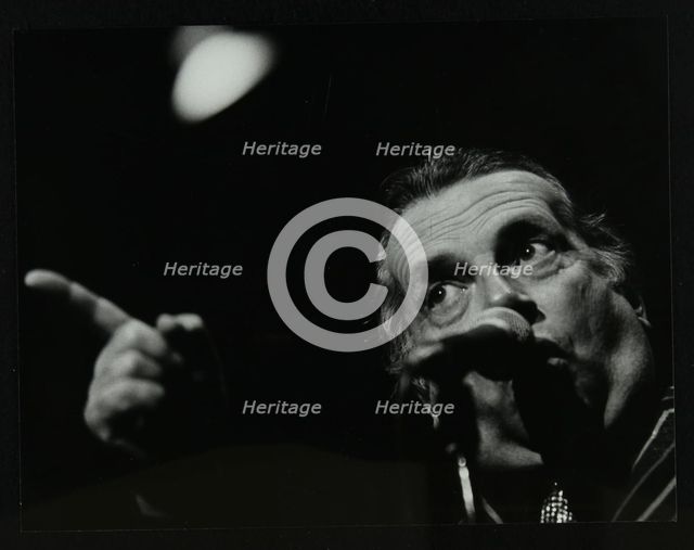 George Melly on stage at the Forum Theatre, Hatfield, Hertfordshire, 8 April 1983. Creator: Denis Williams.