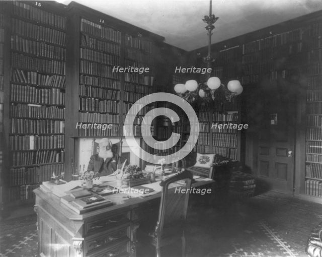 George Bancroft, 1800-1891, half-length portrait, seated at desk in library, facing front, c1880s. Creator: Unknown.