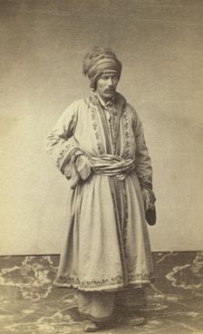 George Kennan, full-length portrait in traditional costume of unidentified..., between 1870 and 86. Creator: Unknown