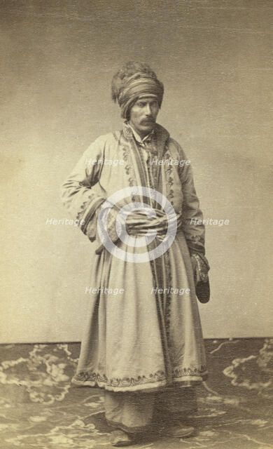 George Kennan, full-length portrait in traditional costume of unidentified..., between 1870 and 86. Creator: Unknown.