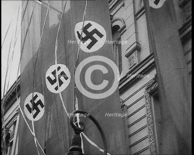 German Nazi Banner Flags Hanging from the Frontage of a Building, 1939. Creator: British Pathe Ltd.