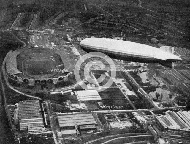 German airship 'Graf Zeppelin' flying over Wembley during the FA Cup Final, London, 1930.Artist: Central Press