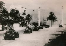 German armoured cars of a Panzer unit drive through Tripolie, West Libya, c.1943.