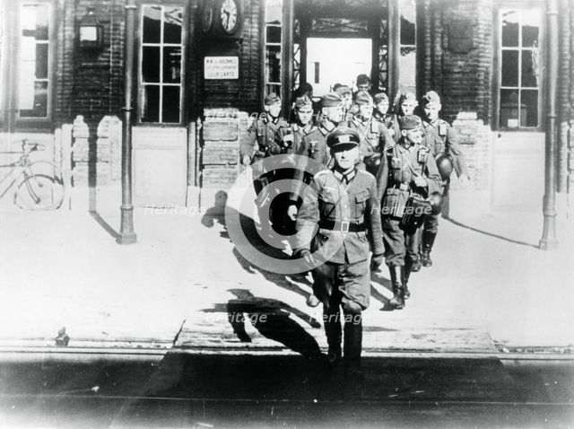 German army officer leading his company onto a railway station platform, Paris, August 1940. Artist: Unknown