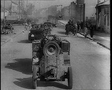 German Army Vehicles With Male Soldiers in Them Driving Down a Street in Warsaw Past..., 1939. Creator: British Pathe Ltd