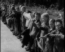 German Children Standing By the Side of a New Road, Some of Them Raising Their Arms in a..., 1937. Creator: British Pathe Ltd